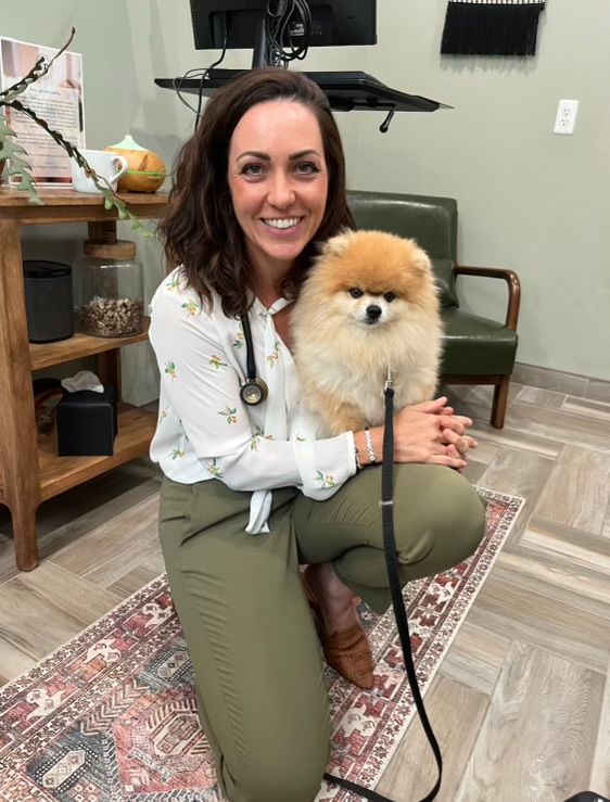 Dr. Kendra Pope providing a wellness check-up for a dog, showcasing expert care in holistic oncology for pets.